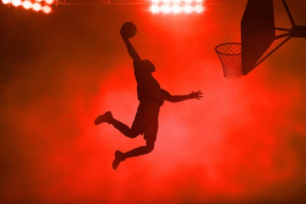 Basketball player silhouette dunking
